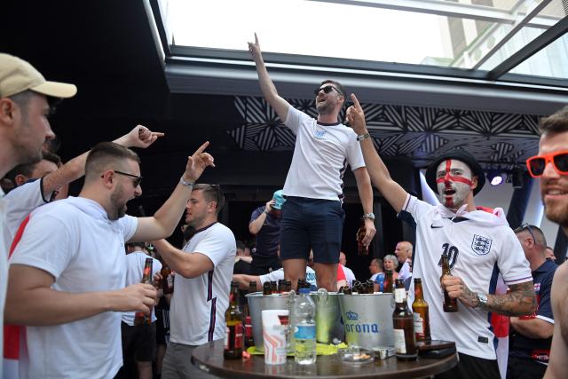 (FILES) England fans cheer prior the UEFA Euro 2024 finale football match between Spain and England, in Benidorm, eastern coast of Spain, on July 14, 2024. The outcome of England's World Cup opener on June 17, 2026 remains uncertain but one result appears far more predictable in Benidorm: a sharp decline in local beer stocks. The Spanish Mediterranean resort, one of Britain's favorite holiday destinations, could serve up to 80,000 litres of beer on Wednesday as England begins its World Cup campaign, according to estimates from the local hospitality industry. (Photo by JOSE JORDAN / AFP)