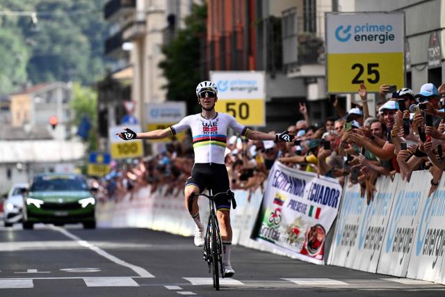 Slovenia's rider Tadej Pogacar of team UAE Emirates - XRG celebrates as he crosses the finish line to win the first stage of the Men's Tour of Switzerland (Tour de Suisse) cycling race, in Sondrio, Italy, on June 17, 2026. (Photo by Marco BERTORELLO / AFP)