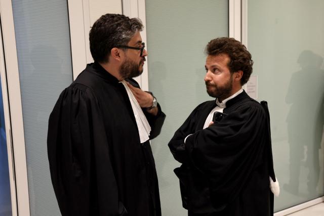 Defense lawyer Karim Laoufi (L) speaks with plaintiff's lawyer Mathias Chichportich during the trial of French controversial humorist Dieudonne MBala MBala for advocating terrorism in Paris on June 17, 2026. (Photo by Mehdi FEDOUACH / AFP)