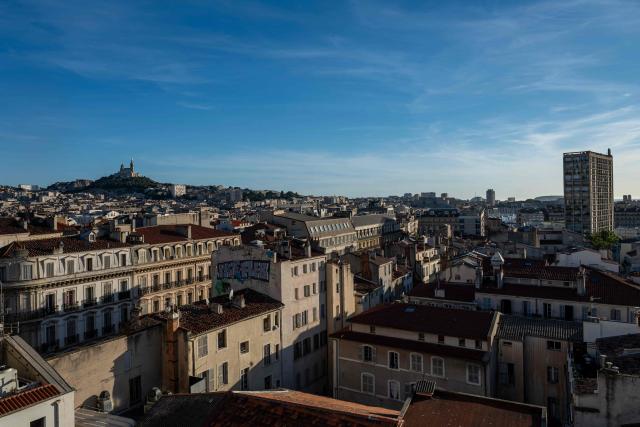 This photograph shows a general view of Marseille and the Notre-Dame de la Garde Basilica taken from the Canebiere district at sunset on June 13, 2026. (Photo by MIGUEL MEDINA / AFP)