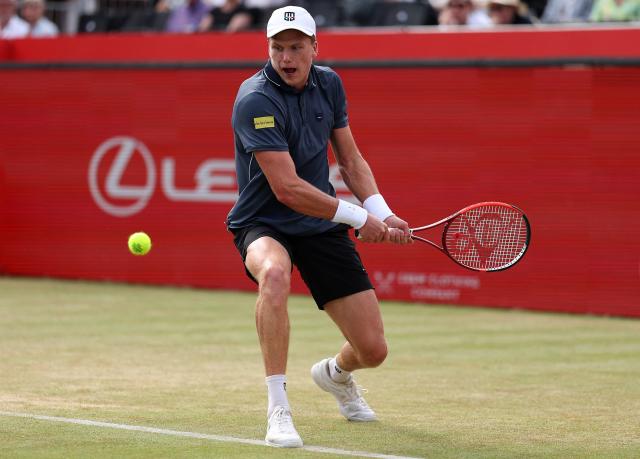US player Jenson Brooksby returns against Argentina's Francisco Cerundolo during their men's singles round of 16 tennis match on day two of the ATP HSBC Championships at Queen's Club in west London on June 17, 2026. (Photo by Adrian Dennis / AFP)