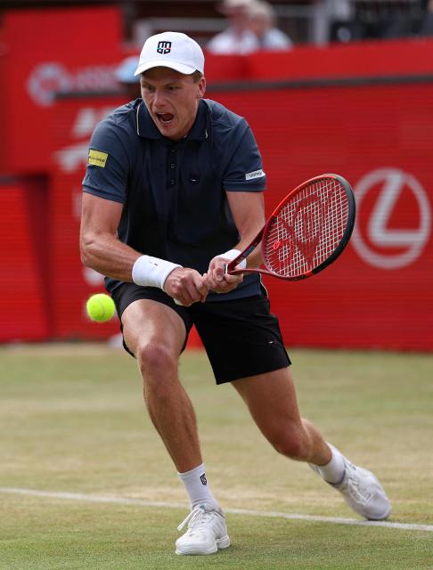 US player Jenson Brooksby returns against Argentina's Francisco Cerundolo during their men's singles round of 16 tennis match on day two of the ATP HSBC Championships at Queen's Club in west London on June 17, 2026. (Photo by Adrian Dennis / AFP)