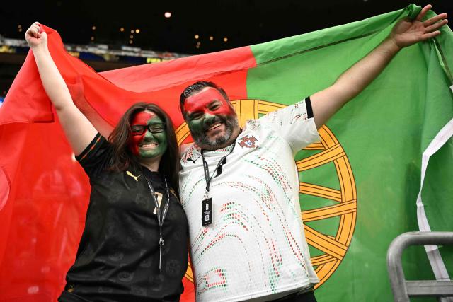 Portugal fans pose ahead of the 2026 World Cup Group K football match between Portugal and the Democratic Republic of Congo at the Houston Stadium in Houston on June 17, 2026.  (Photo by RONALDO SCHEMIDT / AFP)