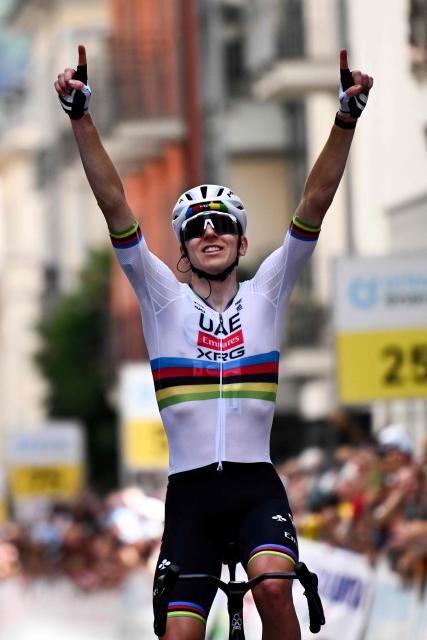 Slovenia's rider Tadej Pogacar of team UAE Emirates - XRG celebrates as he crosses the finish line to win the first stage of the Men's Tour of Switzerland (Tour de Suisse) cycling race, in Sondrio, Italy, on June 17, 2026. (Photo by Marco BERTORELLO / AFP)