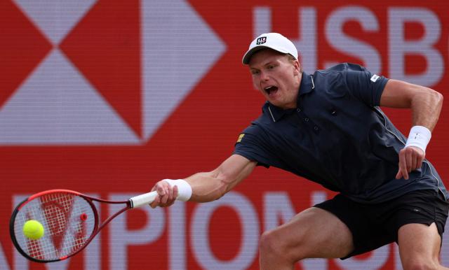 US player Jenson Brooksby returns against Argentina's Francisco Cerundolo during their men's singles round of 16 tennis match on day two of the ATP HSBC Championships at Queen's Club in west London on June 17, 2026. (Photo by Adrian DENNIS / AFP)