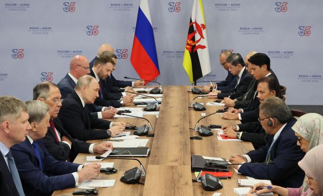 Russia's President Vladimir Putin meets with Brunei's Sultan Hassanal Bolkiah on the sidelines of the Russia-ASEAN summit, which commemorates 35 years of collaboration between Russia and the ASEAN countries, in the central Russian city of Kazan, around 700 kilometres (435 miles) east of the capital Moscow, on June 17, 2026. (Photo by Anastasia Barashkova / POOL / AFP)