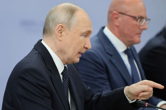 Russia's President Vladimir Putin attends a meeting with Brunei's Sultan on the sidelines of the Russia-ASEAN summit, which commemorates 35 years of collaboration between Russia and the ASEAN countries, in the central Russian city of Kazan, around 700 kilometres (435 miles) east of the capital Moscow, on June 17, 2026. (Photo by Anastasia Barashkova / POOL / AFP)