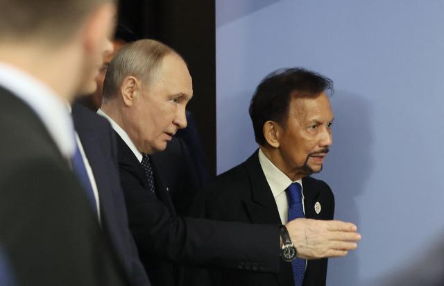 Russia's President Vladimir Putin and Brunei's Sultan Hassanal Bolkiah arrive for a meeting on the sidelines of the Russia-ASEAN summit, which commemorates 35 years of collaboration between Russia and the ASEAN countries, in the central Russian city of Kazan, around 700 kilometres (435 miles) east of the capital Moscow, on June 17, 2026. (Photo by Anastasia Barashkova / POOL / AFP)