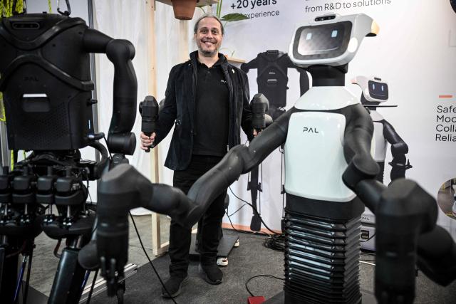 CEO of PAL Robotics Francesco Ferro poses next to robots at the VivaTech technology startups and innovation fair at the Paris Expo Porte de Versailles, in Paris on June 17, 2026. (Photo by JULIEN DE ROSA / AFP)