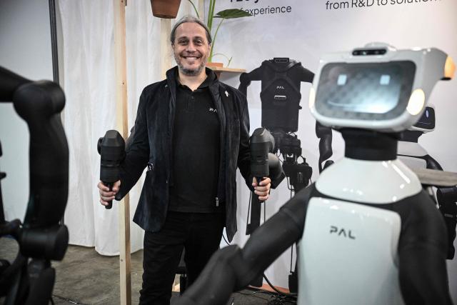 CEO of PAL Robotics Francesco Ferro poses next to robots at the VivaTech technology startups and innovation fair at the Paris Expo Porte de Versailles, in Paris on June 17, 2026. (Photo by JULIEN DE ROSA / AFP)
