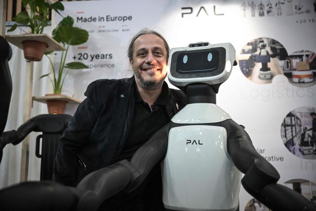 CEO of PAL Robotics Francesco Ferro poses next to robots at the VivaTech technology startups and innovation fair at the Paris Expo Porte de Versailles, in Paris on June 17, 2026. (Photo by JULIEN DE ROSA / AFP)