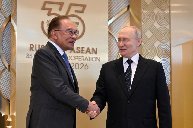 Russia's President Vladimir Putin greets Malaysia's Prime Minister Anwar Ibrahim during a ceremony to welcome Southeast Asian leaders and heads of delegations participating in the Russia-ASEAN summit, which commemorates 35 years of collaboration between Russia and the ASEAN countries, in the central Russian city of Kazan, around 700 kilometres (435 miles) east of the capital Moscow, on June 17, 2026. (Photo by Alexander NEMENOV / AFP)