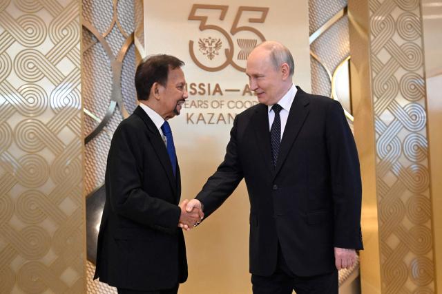 Russia's President Vladimir Putin greets Brunei's Sultan Hassanal Bolkiah during a ceremony to welcome Southeast Asian leaders and heads of delegations participating in the Russia-ASEAN summit, which commemorates 35 years of collaboration between Russia and the ASEAN countries, in the central Russian city of Kazan, around 700 kilometres (435 miles) east of the capital Moscow, on June 17, 2026. (Photo by Alexander NEMENOV / AFP)