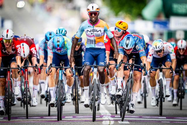 NSN Cycling Team's Eritrean rider Biniam Girmay (C) celebrates as he crosses the finish line ahead of Soudal Quick-Step's Belgian rider Tim Merlier (2nd R) to win the 1st stage of the Tour of Belgium cycling race, 187.9 km starting and finishing in Scherpenheuvel-Zichem, on June 17, 2026. The Belgium Tour takes place from 17 to 21 June. (Photo by JASPER JACOBS / Belga / AFP) / Belgium OUT