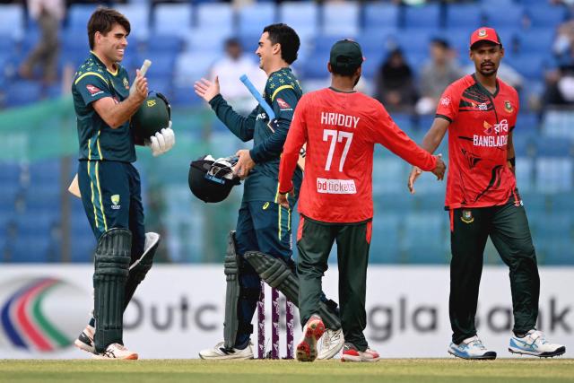 Australia's Xavier Bartlett (L) and Joel Davies (2L) celebrate their team's win as Bangladesh's Mustafizur Rahman (R) shakes hands with captain Towhid Hridoy at the end of their first Twenty20 international cricket match in the Bir Sreshtho Flight Lieutenant Matiur Rahman Stadium of Chattogram on June 17, 2026. (Photo by AFP)