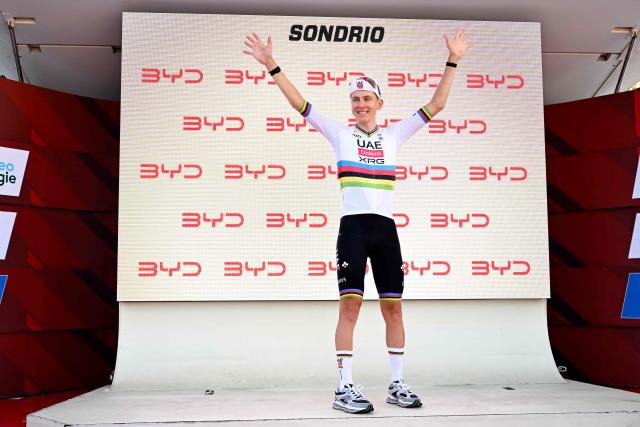 Slovenia's rider Tadej Pogacar of team UAE Emirates - XRG celebrates on the podium of the first stage of the Men's Tour of Switzerland (Tour de Suisse) cycling race, in Sondrio, Italy, on June 17, 2026. (Photo by Marco BERTORELLO / AFP)