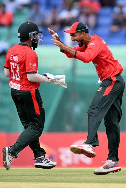 Bangladesh's wicketkeeper Parvez Hossain Emon (L) celebrates with Saif Hassan after taking a catch to dismiss Australia's Nikhil Chaudhary during the first Twenty20 international cricket match between Bangladesh and Australia at the Bir Sreshtho Flight Lieutenant Matiur Rahman Stadium in Chattogram on June 17, 2026. (Photo by AFP)