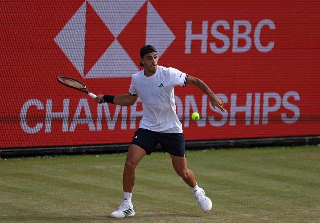 Argentina's Francisco Cerundolo returns against US player Jenson Brooksby during their men's singles round of 16 tennis match on day two of the ATP HSBC Championships at Queen's Club in west London on June 17, 2026. (Photo by Adrian DENNIS / AFP)