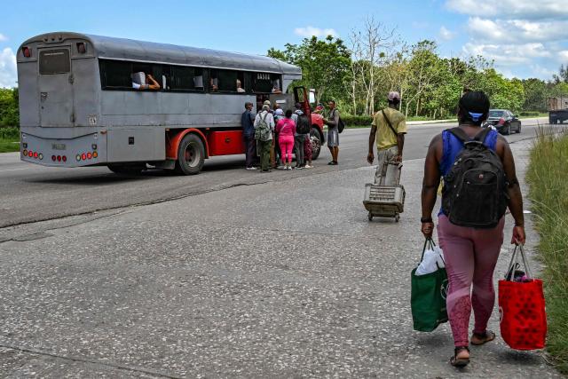 People board a private lorry transporting passengers to the eastern provinces on the National Motorway on the outskirts of Havana on June 16, 2026. New restrictions on interprovincial transport in Cuba come into force on June 18, 2026, with trains running every 16 days, few weekly coaches and a state system for allocating tickets according to criteria of "urgency", amid a severe fuel shortage, under pressure from Washington. (Photo by YAMIL LAGE / AFP)
