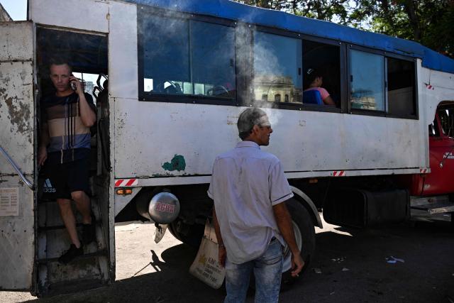 A man gets off a private lorry that transports passengers to the eastern provinces, in Havana on June 16, 2026. New restrictions on interprovincial transport in Cuba come into force on June 18, 2026, with trains running every 16 days, few weekly coaches and a state system for allocating tickets according to criteria of "urgency", amid a severe fuel shortage, under pressure from Washington. (Photo by YAMIL LAGE / AFP)