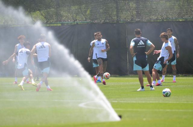 Argentina players play with a ball behind a water sprinkler during training session at Sporting KC Training Centre in Kansas City on June 17, 2026. (Photo by JUAN MABROMATA / AFP)