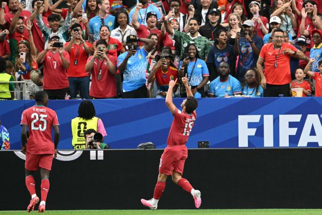TOPSHOT - Portugal's midfielder #15 Joao Neves (C) celebrates after scoring the opening goal during the 2026 World Cup Group K football match between Portugal and the Democratic Republic of Congo at the Houston Stadium in Houston on June 17, 2026.  (Photo by RONALDO SCHEMIDT / AFP)