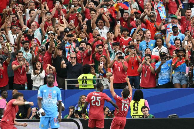 TOPSHOT - Portugal's midfielder #15 Joao Neves (R) celebrates after scoring the opening goal during the 2026 World Cup Group K football match between Portugal and the Democratic Republic of Congo at the Houston Stadium in Houston on June 17, 2026.  (Photo by RONALDO SCHEMIDT / AFP)