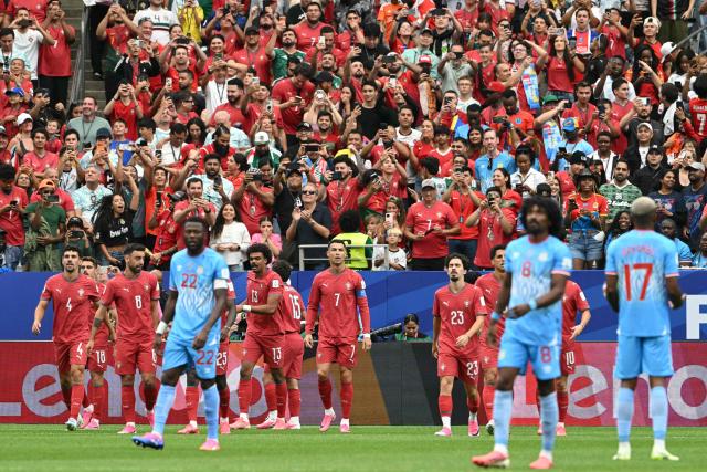 Portugal's forward #07 Cristiano Ronaldo (C) reacts with teammates after his team socred the   opening goal during the 2026 World Cup Group K football match between Portugal and the Democratic Republic of Congo at the Houston Stadium in Houston on June 17, 2026.  (Photo by RONALDO SCHEMIDT / AFP)