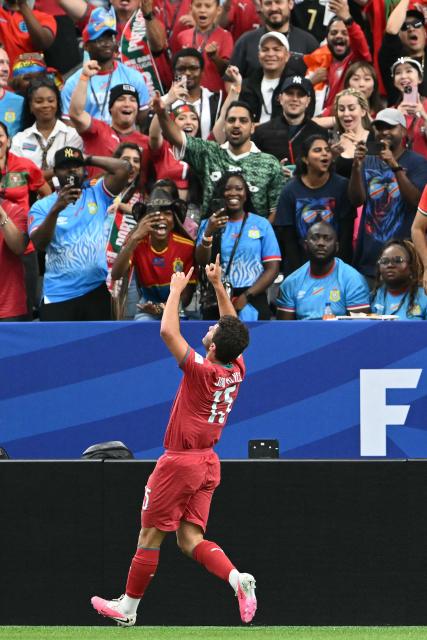 Portugal's midfielder #15 Joao Neves (C) celebrates after scoring the opening goal during the 2026 World Cup Group K football match between Portugal and the Democratic Republic of Congo at the Houston Stadium in Houston on June 17, 2026.  (Photo by RONALDO SCHEMIDT / AFP)