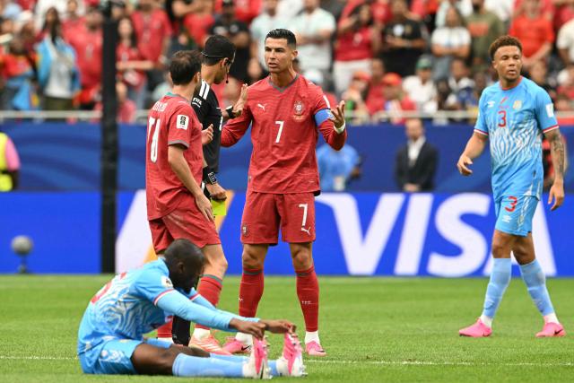 Portugal's forward #07 Cristiano Ronaldo (C) speaks with Qatari referee Abdulrahman Al-Jassim (2nd L) during the 2026 World Cup Group K football match between Portugal and the Democratic Republic of Congo at the Houston Stadium in Houston on June 17, 2026.  (Photo by RONALDO SCHEMIDT / AFP)