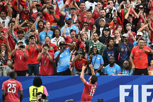 Portugal's midfielder #15 Joao Neves (C) celebrates after scoring the opening goal during the 2026 World Cup Group K football match between Portugal and the Democratic Republic of Congo at the Houston Stadium in Houston on June 17, 2026.  (Photo by RONALDO SCHEMIDT / AFP)