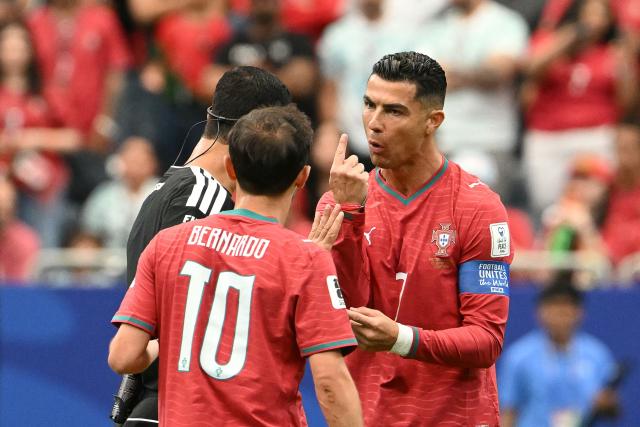 Portugal's forward #07 Cristiano Ronaldo (R) speaks with Qatari referee Abdulrahman Al-Jassim  during the 2026 World Cup Group K football match between Portugal and the Democratic Republic of Congo at the Houston Stadium in Houston on June 17, 2026.  (Photo by RONALDO SCHEMIDT / AFP)