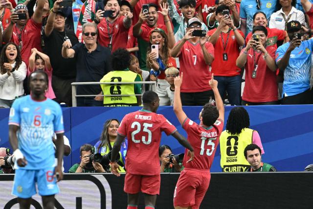 Portugal's midfielder #15 Joao Neves (R) celebrates after scoring the opening goal during the 2026 World Cup Group K football match between Portugal and the Democratic Republic of Congo at the Houston Stadium in Houston on June 17, 2026.  (Photo by RONALDO SCHEMIDT / AFP)