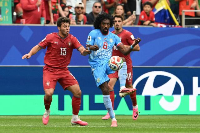 Congo DR's midfielder #08 Samuel Moutoussamy (C) fights for the ball with Portugal's midfielder #15 Joao Neves (L)  during the 2026 World Cup Group K football match between Portugal and the Democratic Republic of Congo at the Houston Stadium in Houston on June 17, 2026.  (Photo by RONALDO SCHEMIDT / AFP)