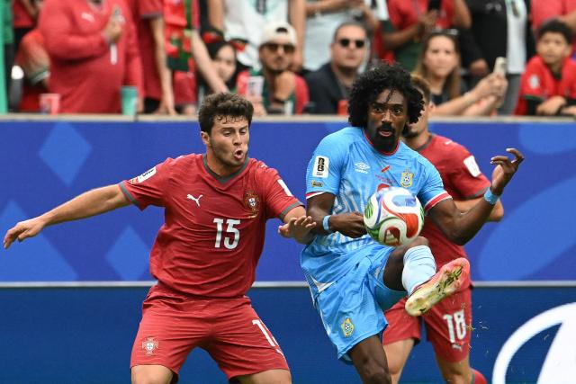 TOPSHOT - Congo DR's midfielder #08 Samuel Moutoussamy (R) fights for the ball with Portugal's midfielder #15 Joao Neves (L) during the 2026 World Cup Group K football match between Portugal and the Democratic Republic of Congo at the Houston Stadium in Houston on June 17, 2026.  (Photo by RONALDO SCHEMIDT / AFP)