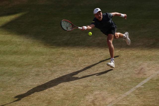 US player Jenson Brooksby returns against Argentina's Francisco Cerundolo during their men's singles round of 16 tennis match on day two of the ATP HSBC Championships at Queen's Club in west London on June 17, 2026. (Photo by Adrian DENNIS / AFP)