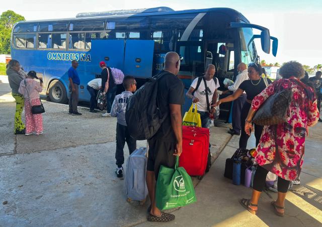 People arrive on a coach at Ciego de Avila, Cuba, on June 15, 2026. New restrictions on interprovincial transport in Cuba come into force on June 18, 2026, with trains running every 16 days, few weekly coaches and a state system for allocating tickets according to criteria of "urgency", amid a severe fuel shortage, under pressure from Washington. (Photo by AFP)