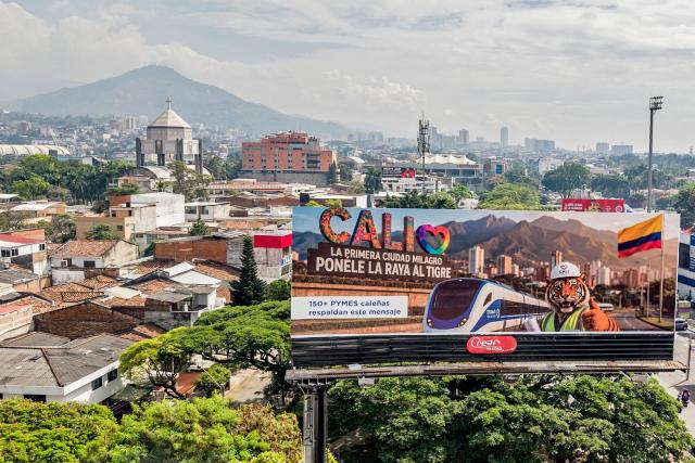Aerial view of a billboards reading “Cali, the first miracle city. Put a stripe on the tiger” inviting to vote for Colombia's presidential canditate Abelardo de la Espriella, of the Salvadores de la Patria movement, in the upcoming presidential election in Cali, Colombia, on June 17, 2026. Colombians vote on June 21, 2026 in a presidential runoff pitting a hard-right opera-singer-turned-lawyer against a leftist senator, an election with stark consequences for the country's stumbling peace process with armed groups and strained ties with Washington. (Photo by JOAQUIN SARMIENTO / AFP)