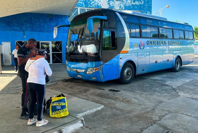 People arrive on a coach at Ciego de Avila, Cuba, on June 15, 2026. New restrictions on interprovincial transport in Cuba come into force on June 18, 2026, with trains running every 16 days, few weekly coaches and a state system for allocating tickets according to criteria of "urgency", amid a severe fuel shortage, under pressure from Washington. (Photo by AFP)