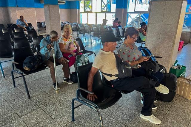 People wait at the bus terminal in Ciego de Avila, Cuba, on June 15, 2026. New restrictions on interprovincial transport in Cuba come into force on June 18, 2026, with trains running every 16 days, few weekly coaches and a state system for allocating tickets according to criteria of "urgency", amid a severe fuel shortage, under pressure from Washington. (Photo by AFP)