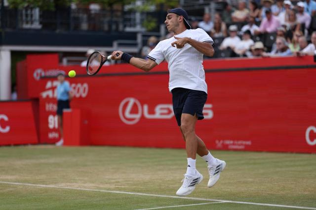 Argentina's Francisco Cerundolo returns against US player Jenson Brooksby during their men's singles round of 16 tennis match on day two of the ATP HSBC Championships at Queen's Club in west London on June 17, 2026. (Photo by Adrian Dennis / AFP)