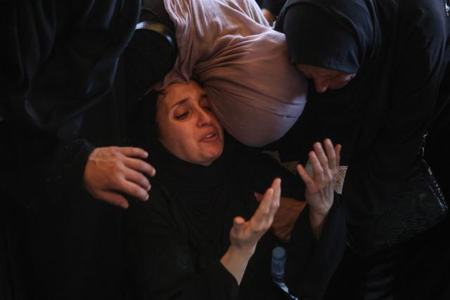 Displaced Palestinian women mourn loved ones killed in an Israeli airstrike during a funeral at Nasser Hospital in Khan Yunis, in the southern Gaza Strip, on June 17, 2026. A ceasefire has been in place in Gaza since October, but Israel reserves the right to strike targets it deems a threat. The territory remains gripped by daily violence as Israeli strikes continue, with both the military and Hamas accusing one another of violating the truce. (Photo by Bashar Taleb / AFP)