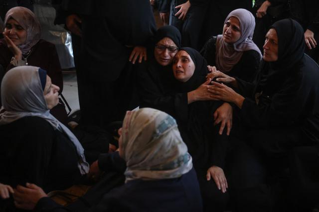 Displaced Palestinian women mourn loved ones killed in an Israeli airstrike during a funeral at Nasser Hospital in Khan Yunis, in the southern Gaza Strip, on June 17, 2026. A ceasefire has been in place in Gaza since October, but Israel reserves the right to strike targets it deems a threat. The territory remains gripped by daily violence as Israeli strikes continue, with both the military and Hamas accusing one another of violating the truce. (Photo by Bashar Taleb / AFP)