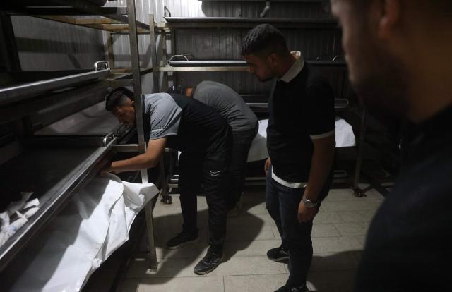 Palestinian men look at the bodies of victims who were reportedly killed in an Israeli air strike at Nasser Hospital in Khan Yunis, in the southern Gaza Strip, on June 17, 2026. A ceasefire has been in place in Gaza since October, but Israel reserves the right to strike targets it deems a threat. The territory remains gripped by daily violence as Israeli strikes continue, with both the military and Hamas accusing one another of violating the truce. (Photo by Bashar Taleb / AFP)