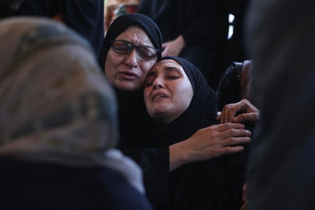 Displaced Palestinian women mourn loved ones killed in an Israeli airstrike during a funeral at Nasser Hospital in Khan Yunis, in the southern Gaza Strip, on June 17, 2026. A ceasefire has been in place in Gaza since October, but Israel reserves the right to strike targets it deems a threat. The territory remains gripped by daily violence as Israeli strikes continue, with both the military and Hamas accusing one another of violating the truce. (Photo by Bashar Taleb / AFP)