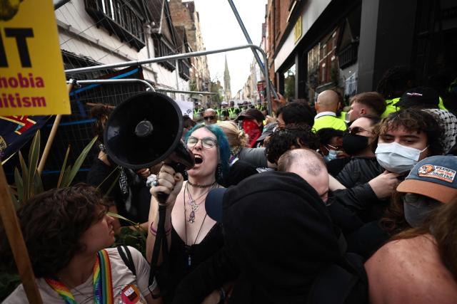 Activists attempt to push over a security fence near The Oxford Union, in Oxford, western England, on June 17, 2026, where British far-right activist Tommy Robinson, real name Stephen Yaxley-Lennon, is giving a speech. (Photo by Henry NICHOLLS / AFP)