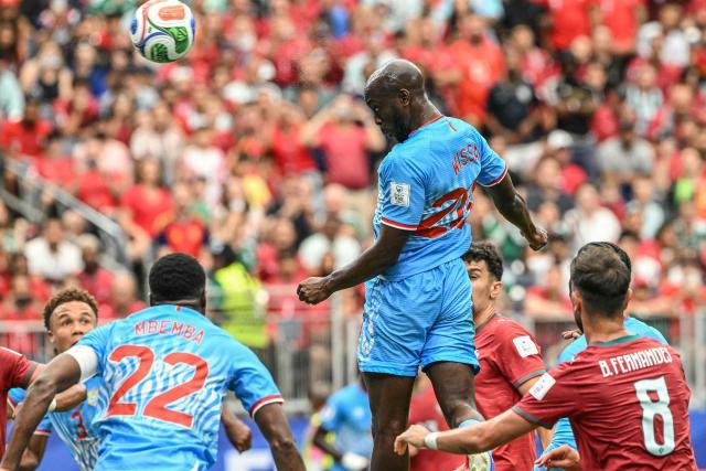 Congo DR's forward #20 Yoane Wissa heads the ball and scores his team's first goal  during the 2026 World Cup Group K football match between Portugal and the Democratic Republic of Congo at the Houston Stadium in Houston on June 17, 2026.  (Photo by RONALDO SCHEMIDT / AFP)
