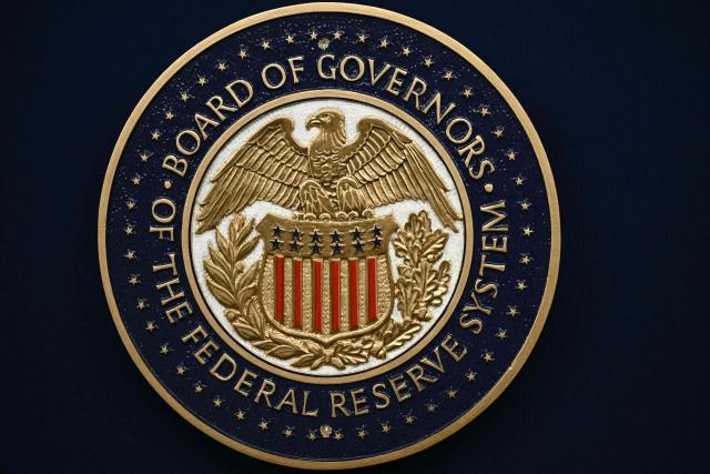 The US Federal Reserve seal is seen on a lectern before US Federal Reserve chairman Kevin Warsh holds a press conference in Washington, DC, on June 17, 2026. (Photo by Brendan SMIALOWSKI / AFP)