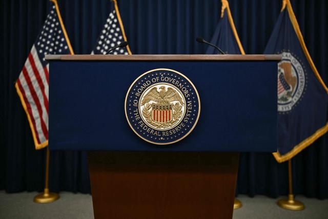 The US Federal Reserve seal is seen on a lectern before US Federal Reserve chairman Kevin Warsh holds a press conference in Washington, DC, on June 17, 2026. (Photo by Brendan SMIALOWSKI / AFP)