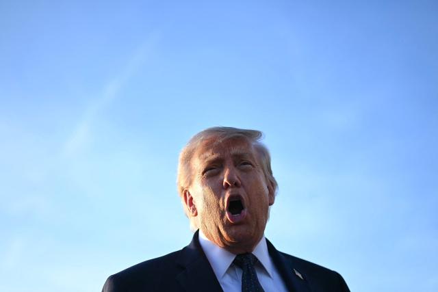 US President Donald Trump addresses the media on the tarmac after arriving at Paris Orly Airport enroute to a dinner to celebrate the 250th anniversary of the independence of the United States, at Orly Airport, south of Paris, on June 17, 2026. (Photo by Mandel NGAN / AFP)